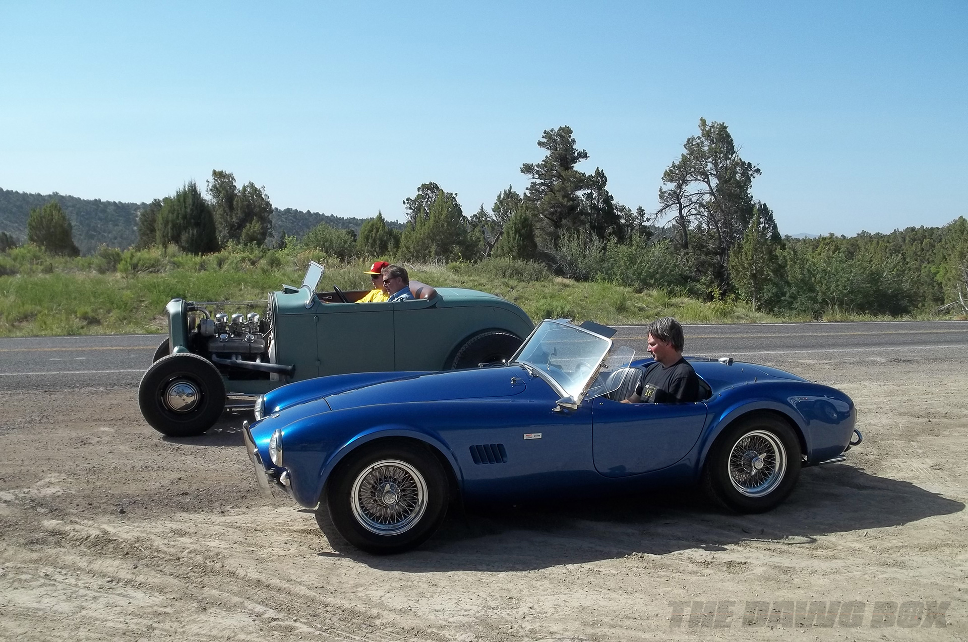 Henry Astor’s ’32 Ford Roadster next to a blue Shelby AC Cobra