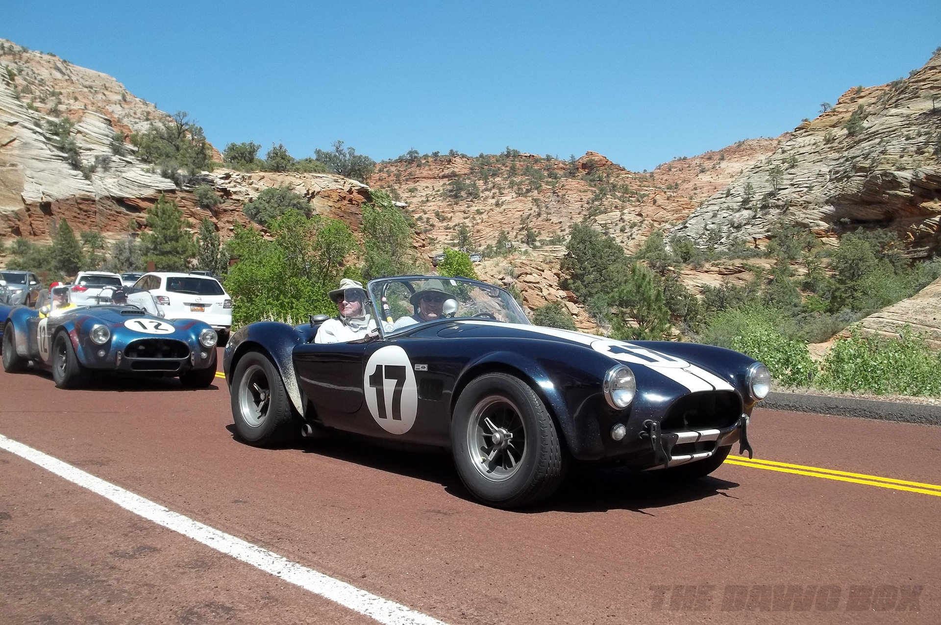a black and blue Shelby AC Cobra on a scenic grand Canyon highway