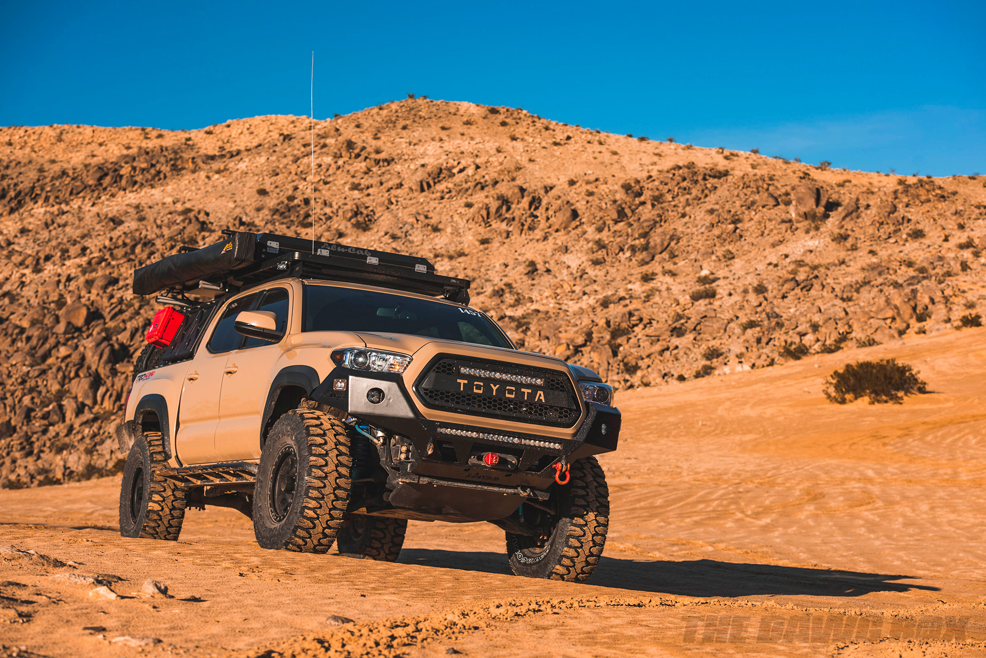 Toyota Tacoma with 35 inch Milestar Patagonia MT tires driving through a sandy desert