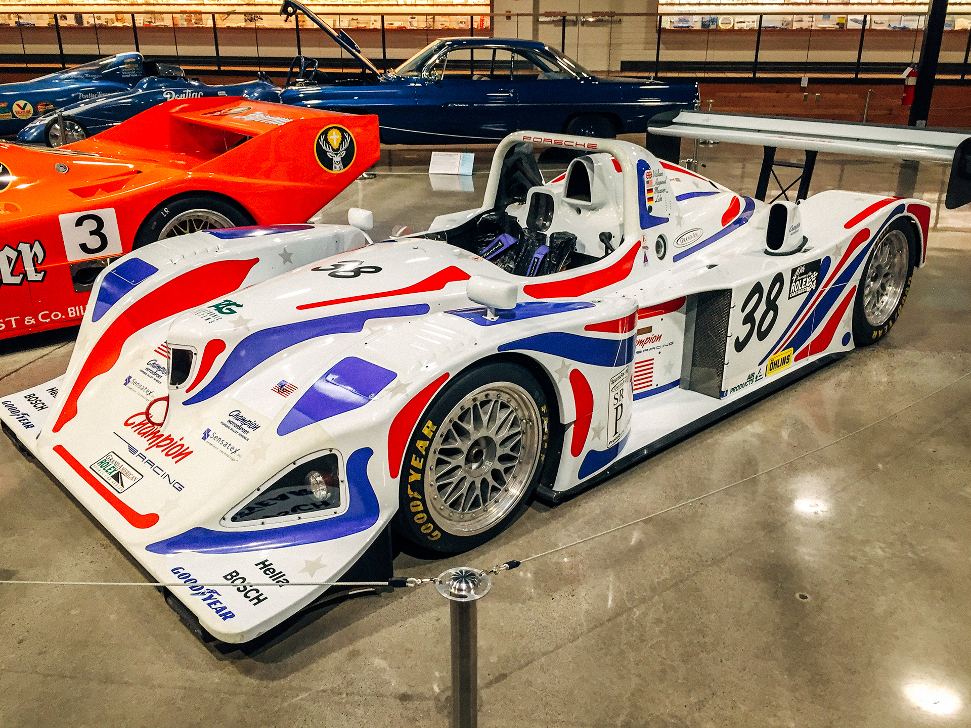 white, blue, and red champion racing race car at the World of Speed Museum