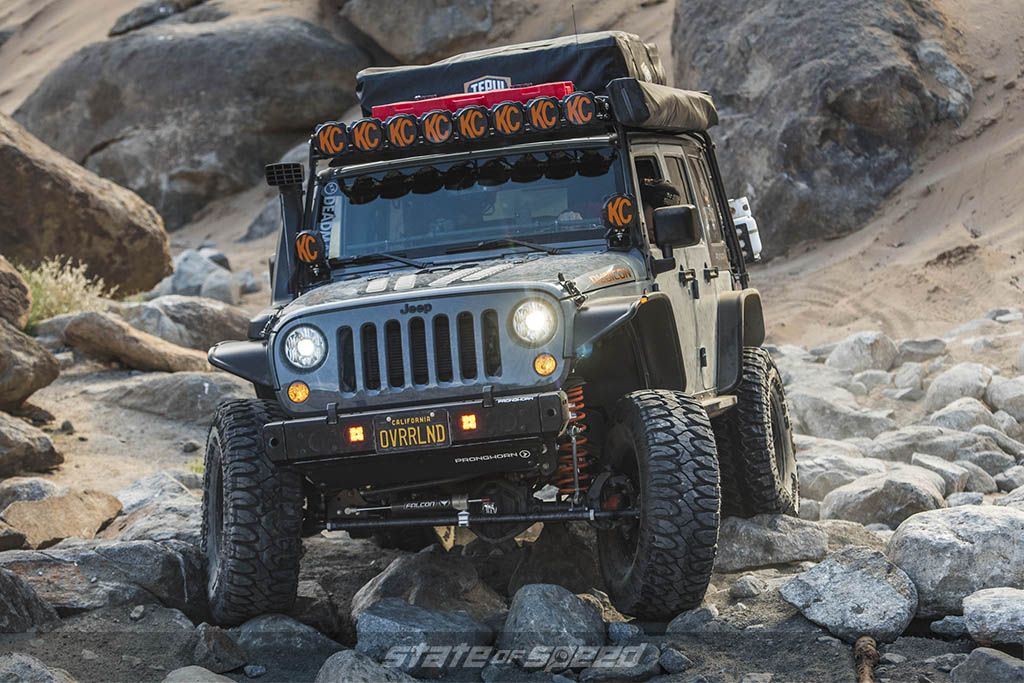 Overland jeep going over rocks