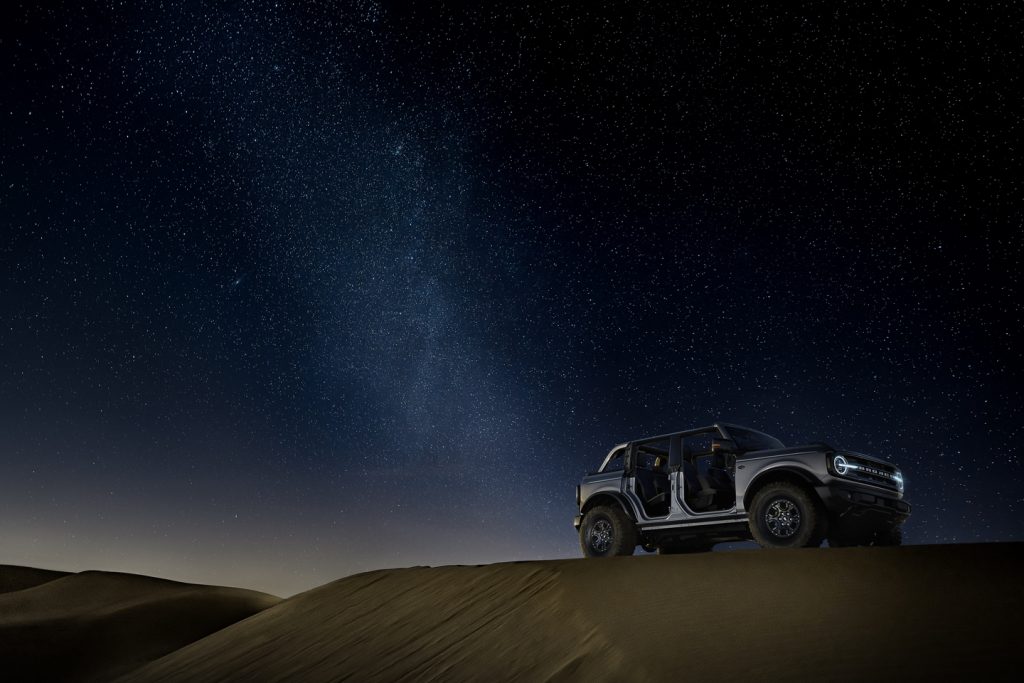2021 offroad ford with removable doors in the desert under a night sky