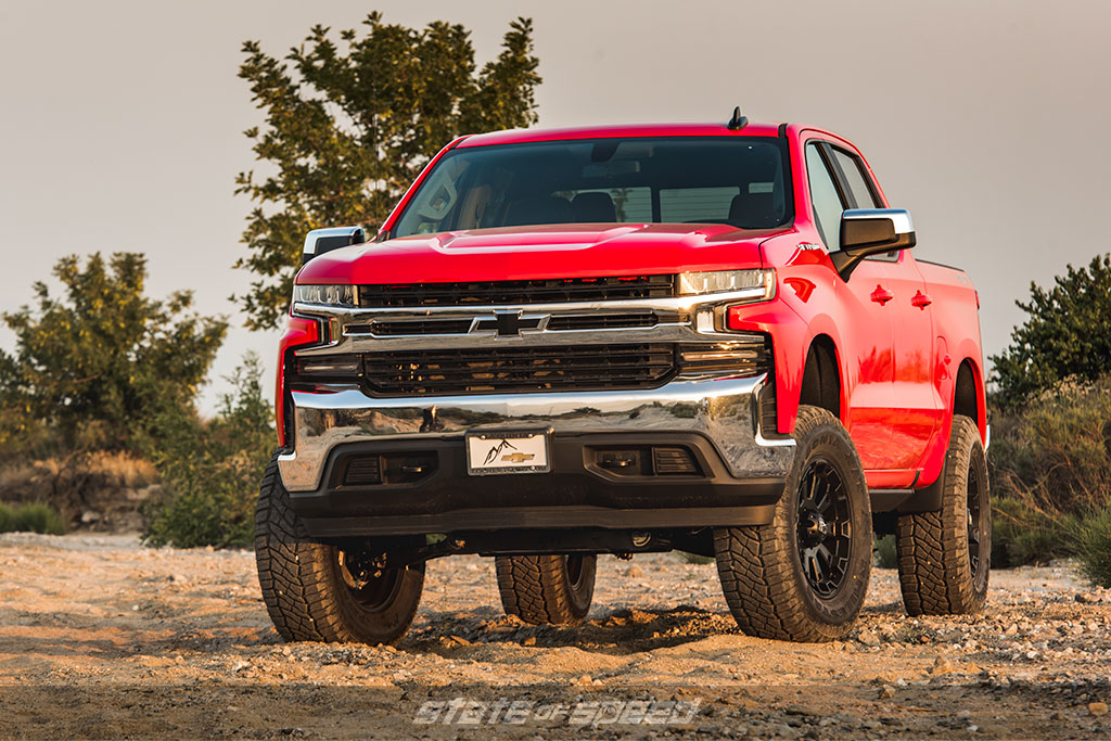 Red pickup truck with offroad tires