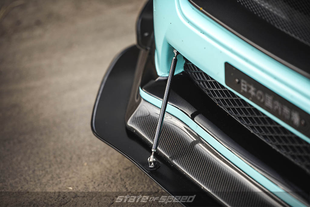 blue subaru wrx with carbon fiber lip and splitter
