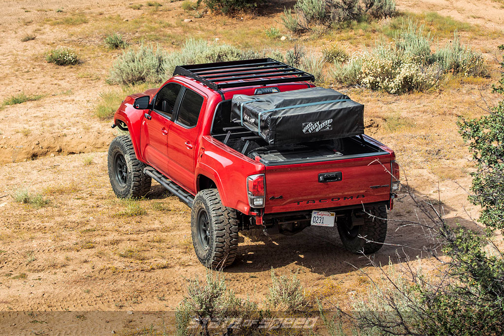 Red overland toyota tacoma with Patagonia MT offroad tires