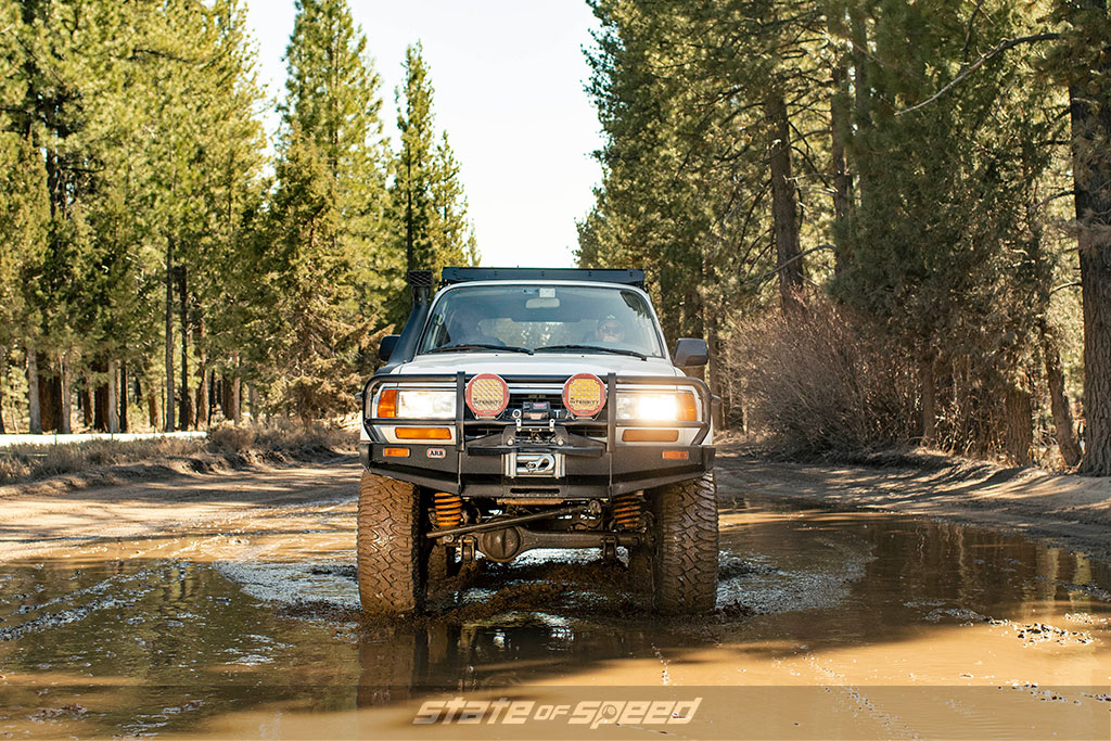Toyota Land Cruiser rolling through mud with Milestar Patagonia MT Offroad Tires