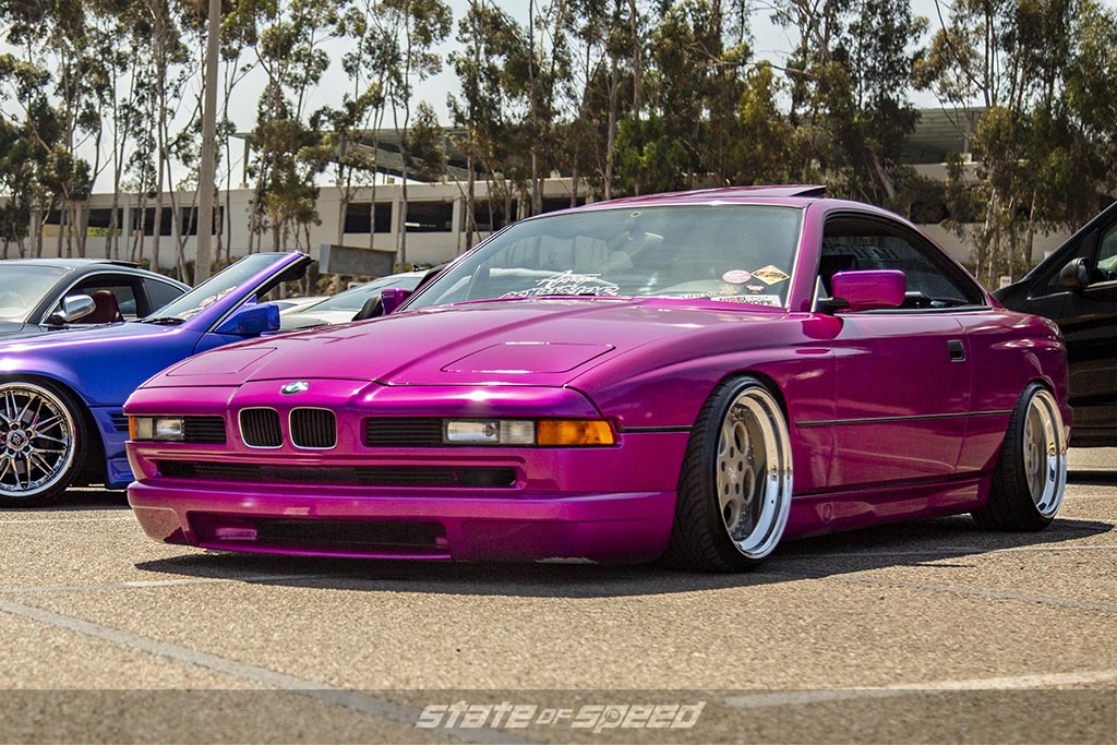slammed with an air bag system Pink BMW 8-series e31 at an outdoor car show