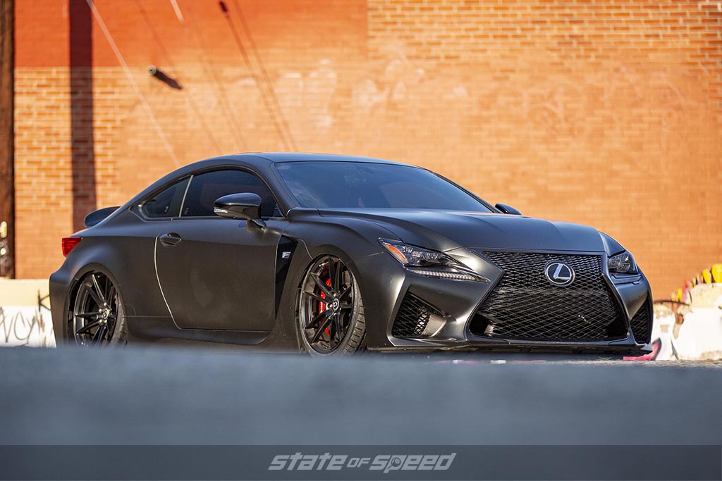 Dark Grey Lexus RC-F with a red brick background